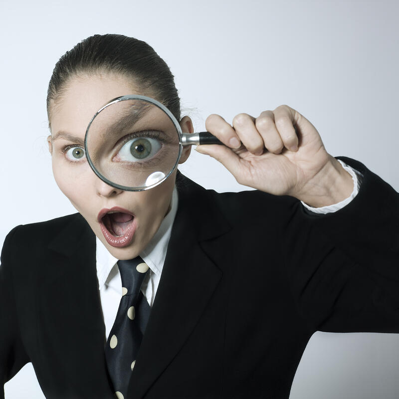 woman_looking_through_magnifying_glass